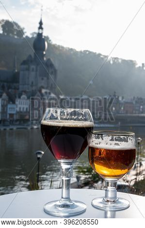 Drinking Of Dark And Strong Belgian Abbey Beer With Cheeses With Nice View On Maas River And Town Di