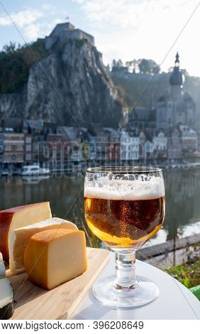 Drinking Of Dark And Strong Belgian Abbey Beer With Cheeses With Nice View On Maas River And Town Di