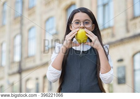 Little Kid In School Uniform Bite Natural Apple Outdoors, Healthy Eating.