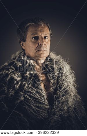 Solid Middle-aged Man In A Fur Mantle