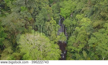 Aerial View Of Forest And River Towards Labuhan Kebo Waterfall Located In Munduk, Bali