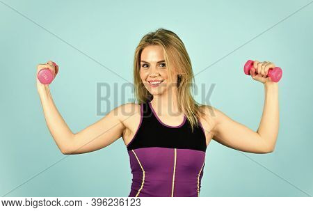 Great Progress. Slim Girl Doing Triceps Exercise With Dumbbell In The Gym. Coach Dressed In Sport Cl