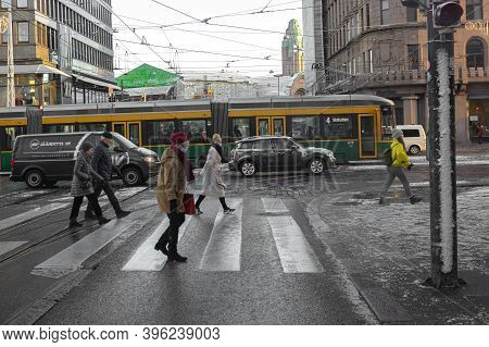 Helsinki, Finland November 20, 2020 People Cross The Road, First Snow On City Streets. High Quality 