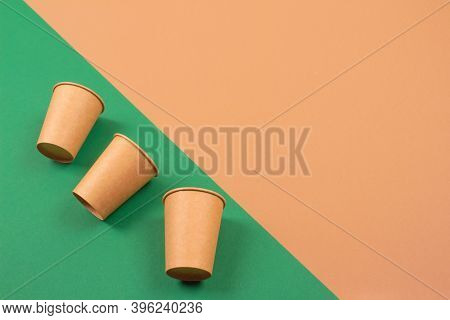 Set Of Eco-friendly Takeaway Beverages Cups - Kraft Paper Coffee Cups On Green And Brown Background 