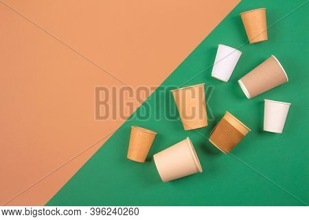 Different Eco-friendly Takeaway Beverages Cups - Kraft Paper Coffee Cups On Green And Brown Backgrou