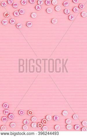 Alphabet beads border pink background