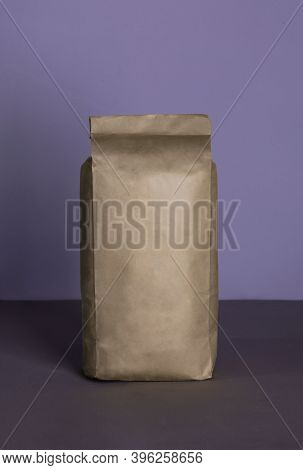Small Blank Bulky Kraft Package With Product On A Purple-lilac Background . Ready For Shipping, Deli