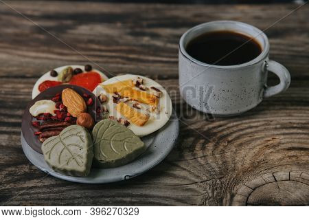 Chocolates With Dried Fruits And A Cup Of Espresso Coffee.