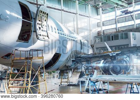 Passenger Jet Plane Under Maintenance In The Hangar. Checking Mechanical Systems For Flight Operatio