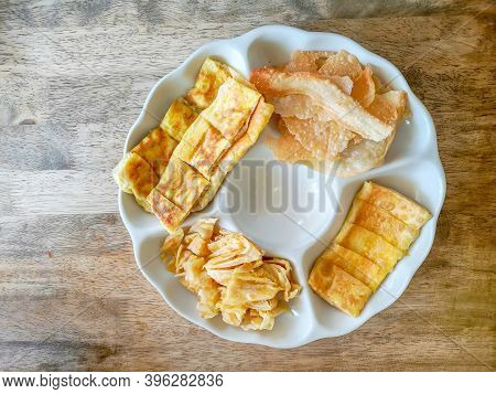 Top View Image, A White Plate Of Yellow Brown Crunchy And Crispy Roti Or Bolloon Bread Fired Indian 