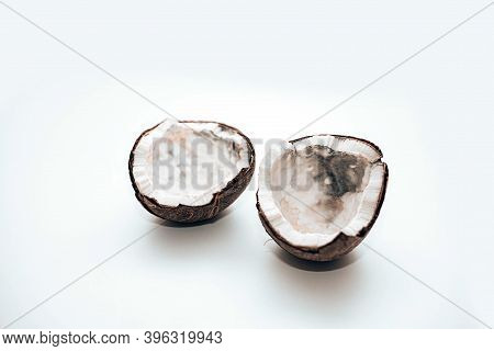 Two Halves Of Coconut Spoiled By Mold Isolated On White Background, Flat Lay. Ugly Food.