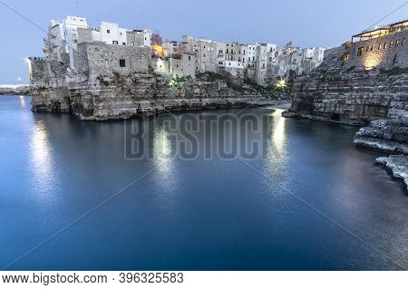 Polignano A Mare, Puglia - Italy. Night At Cala Paura Gulf With Bastione Di Santo Stefano And Lama M