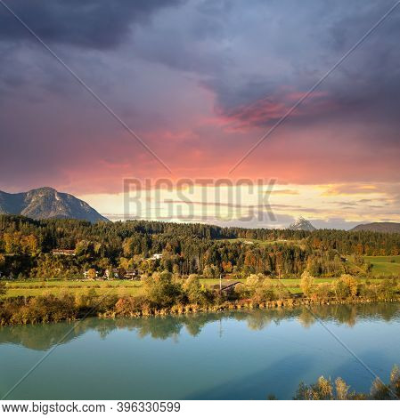 Aerial View Of Green Meadows With Villages And Forest In Austrian Alps Mountains.