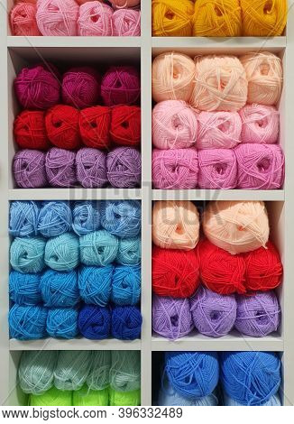 Multicolored Yarns Of Wool For Knitting On Shelves In The Haberdashery Shop. Knitwork Handkraft Conc