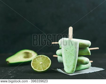 Homemade Raw Vegan Avocado Lime Popsicle. Sugar-free, Non-dairy Green Ice Cream On Black Textured Ba
