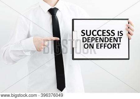 White Sheet On The Tablet With Text Success Is Dependent On Effort In Male Hands On A Light Backgrou
