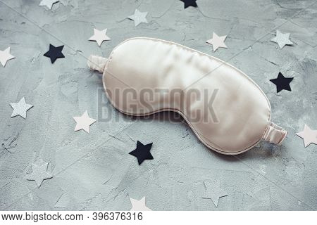 Pink Satin Eye Sleepink Mask And Pink And Sillver Paper Stars Confetti On Gray Background. Sweet Dre
