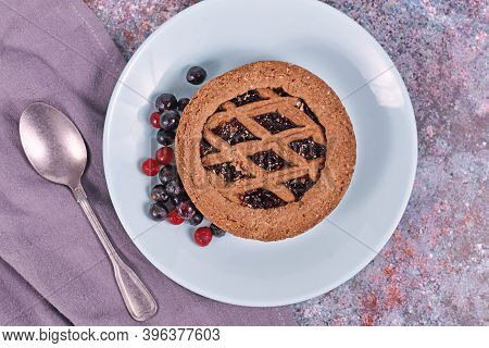 Small Homemade Tartlet Called 'linzertorte', A Traditional Austrian Shortcake Pastry Topped With Fru