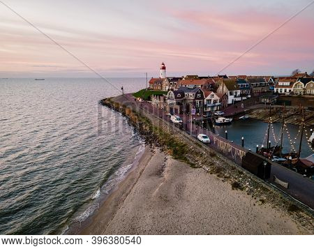 Urk Lighthouse With Old Harbor During Sunset, Urk Is A Small Village By The Lake Ijsselmeer In The N