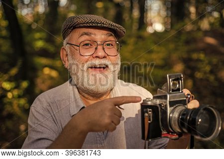 Look At This. Old Photographer Pointing At Retro Camera. Bearded Man Pointing Finger Outdoors. Point