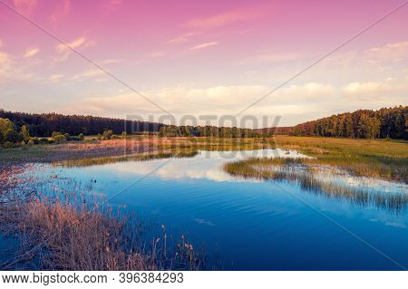 Magical Sunrise Over The Lake With A Beautiful Reflection On The Water. Serene Lake In The Early Mor