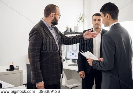 The Chief Of The Construction Company Holds A Standing Meeting With Subordinates, Gives Instructions