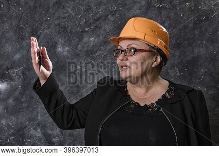 Middle-aged Woman Construction Superintendent In Helmet Studio Portrait.
