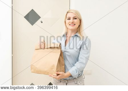 Transportation, Post And People Concept - Smiling Young Woman Opening Cardboard Box At Home