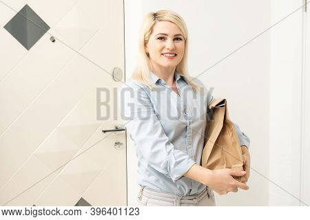 Transportation, Post And People Concept - Smiling Young Woman Opening Cardboard Box At Home