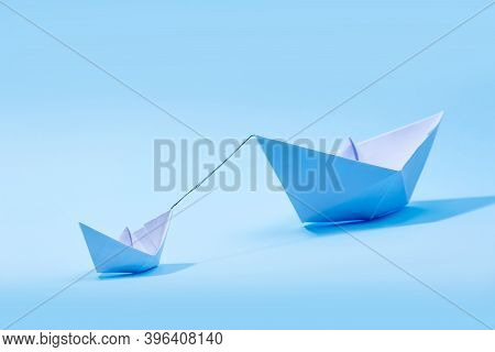 Paper Boats - Tugboat Or Remorker Pulling A Big Boat On Blue Background. Little Helper Concept, Tugb