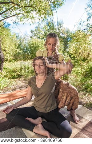 Girl On Massage In Nature With Massage Therapist.