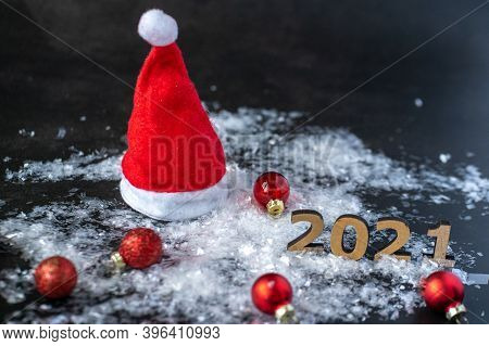 The Numbers Of The New Year 2021 Stand On White Snow Next To Scattered Red Balls Of Christmas Tree D