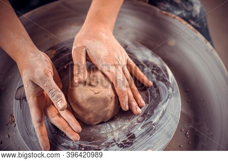 Creating Vase Of Clay Close-up. Master Crock. The Sculptor In The Workshop Makes A Jug Out Of Earthe