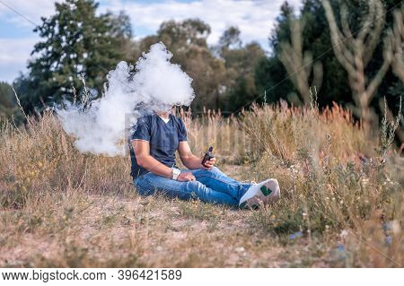 Stylish Vape Man Vaping An E-cigarette. The Man Smokes.