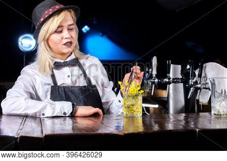 Professional Woman Tapster Places The Finishing Touches On A Drink