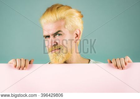 Serious Man With Blank Advertising Board On Color Background. Male Model Holding White Board. Copy S