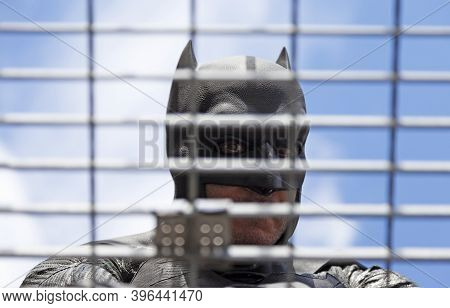 Umea, Norrland Sweden - September 5, 2020: Steel Lattice In Front Of Character Dressed As Batman