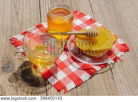 Jar Of Linden Honey, Cup Of Linden Tea And Linden Flowers On Wooden Table On A Sunny Day