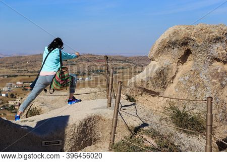 Uchisar, Turkey - October 4, 2020: An Unidentified Young Woman Tries To Capture An Unusual Shot Of T