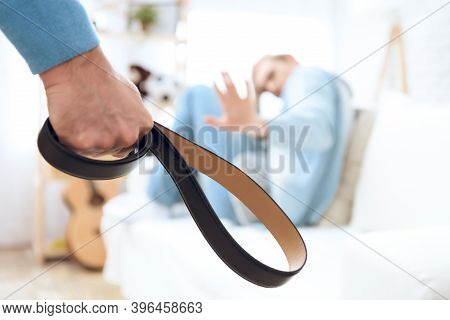 Father Comes To His Son With Belt Ho Hit Him. Troubled Teenager Isn't Defending Himself.