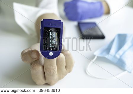 Woman Using Pulse Oximeter To Show By Hand The Symbol Of The Fuck Off. Coronavirus Concept.