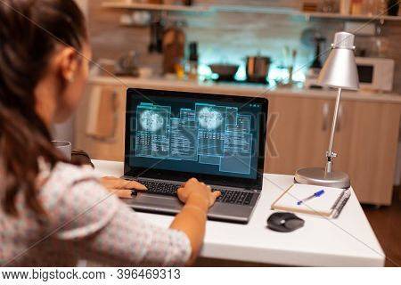 Female Hacer Cracking Security Firewall Late At Night From Home. Programmer Writing A Dangerous Malw
