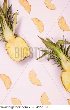 Ripe Juicy Pineapple On Pink Background And Dried Pineapple Wedges Around. Fruit Chips. Healthy Eati