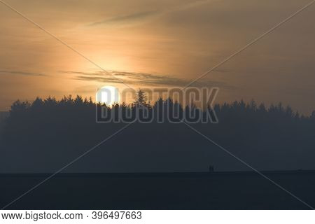 Three People And A Dog Walk Along The Top Of A Dam Wall At Redmires Reservoirs Near Sheffield. Behin