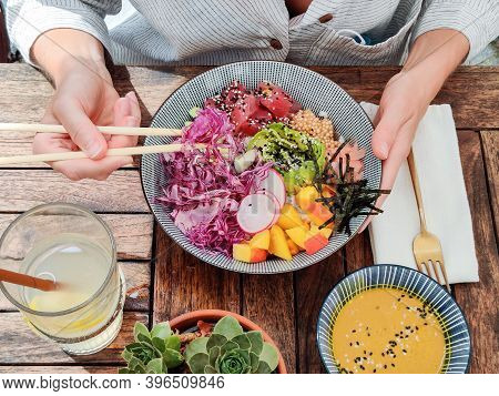 Woman Eating Tasty Colorful Healthy Natural Organic Vegetarian Hawaiian Poke Bowl Using Asian Chopst