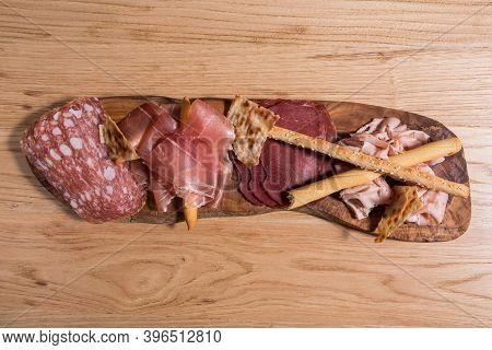 Set Of Cold Cured Spanish Meat Ham, Mortadela And Lomo On A Wooden Background.