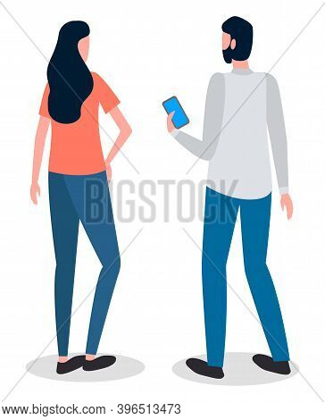 Man And Woman Talking To Each Other. Man Is Holding A Mobile Phone In His Hand And Looking At The Sc