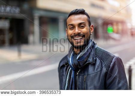 Portrait of a handsome young man on the city street 
