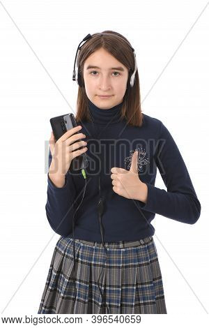 Pre-adolescent Girl Listening To Music On Black Smartphone. Isolated On White Background. High Resol