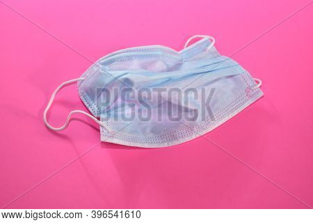 Crumpled Used Protective Medical Mask On A Bright Pink Fuchsi Background. Tired Of Inhibitions, No F